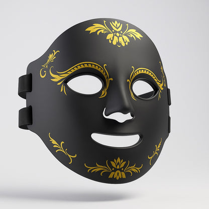 Black mask with gold decorative patterns on a light gray background