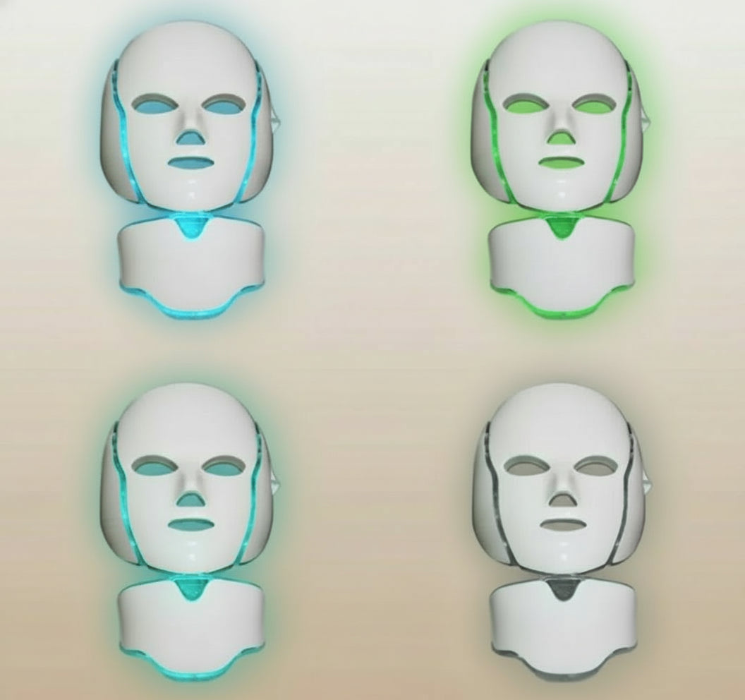 Four LED face masks with different colored lights on a white background
