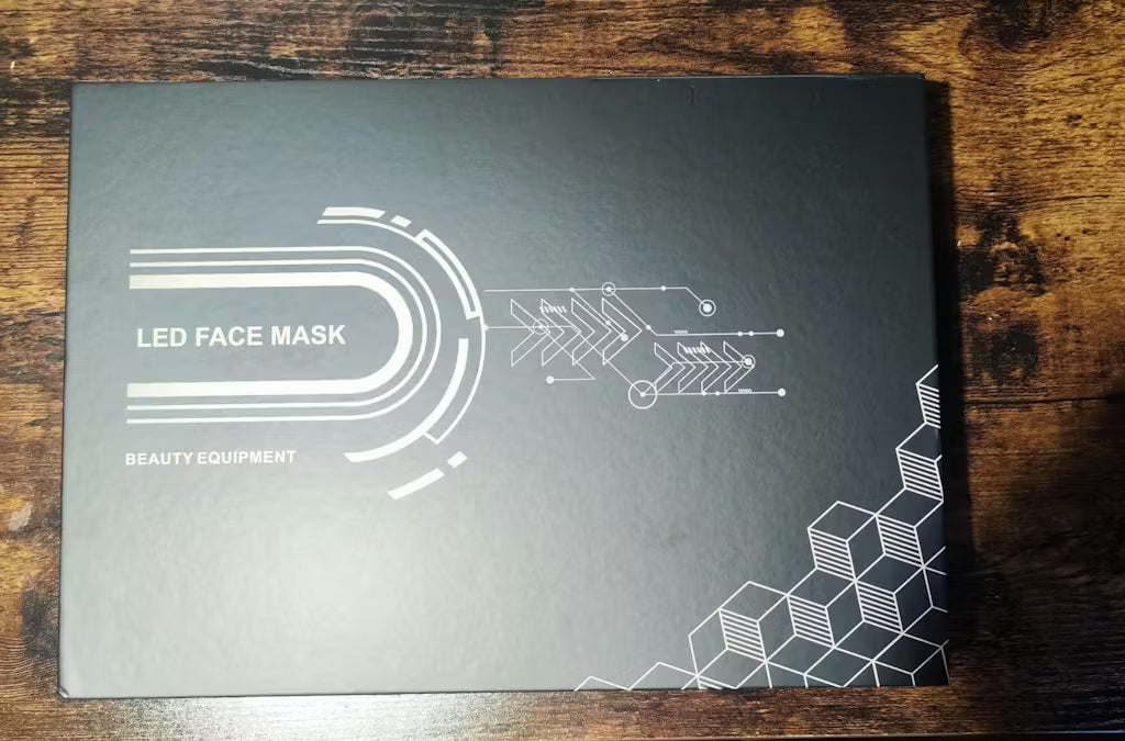 Black box with white line art design and text on a wooden surface