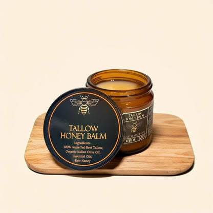 Tallow Honey Balm jar with a lid, surrounded by oranges on a wooden board.
