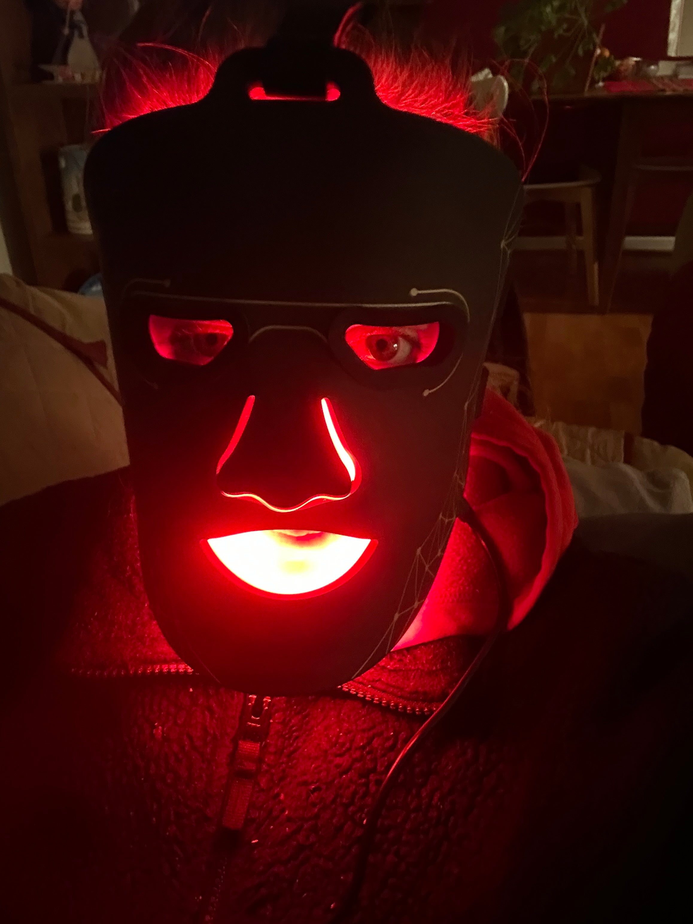 Woman Wearing red light face mask 