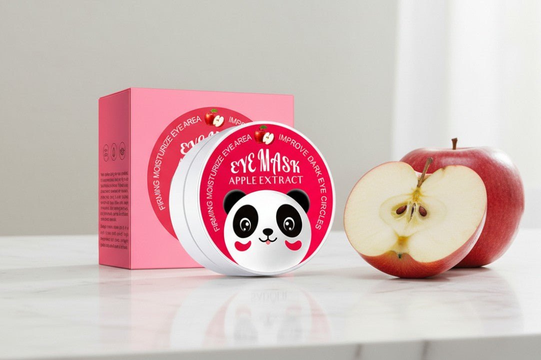 Eye mask with apple extract packaging and an apple on a white surface