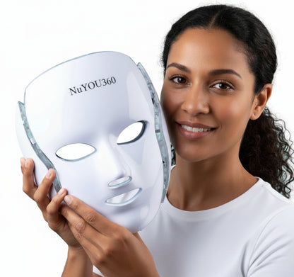 Woman holding a Nutriskin LED face mask against a light blue background