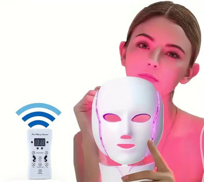 Woman holding a LED face mask with remote control on a white background