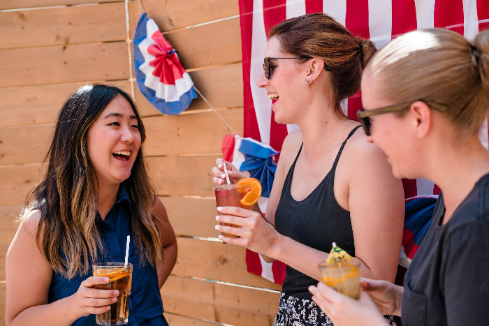 Women laughing with American Flad in the background