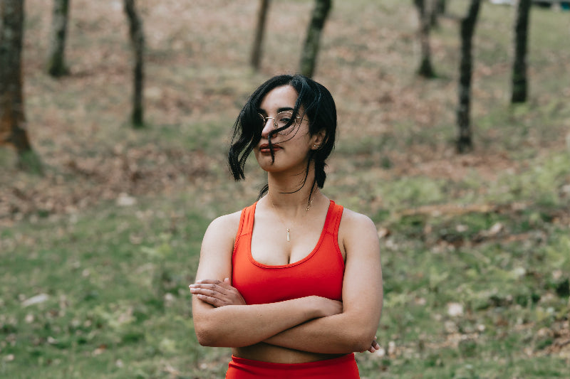  woman-in-vibrant-red-top-crosses-her-arms