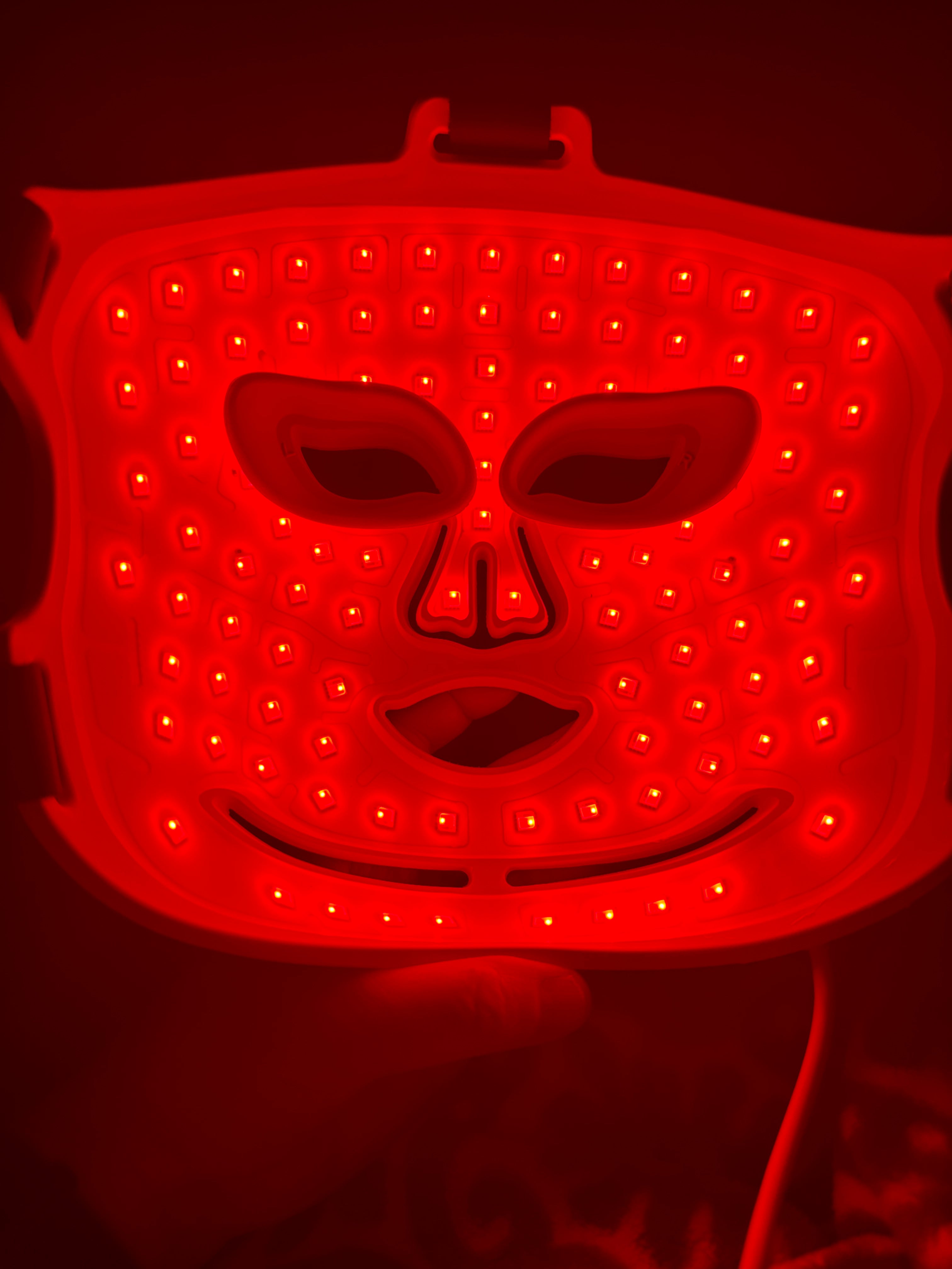 Red LED light pad with a dark background