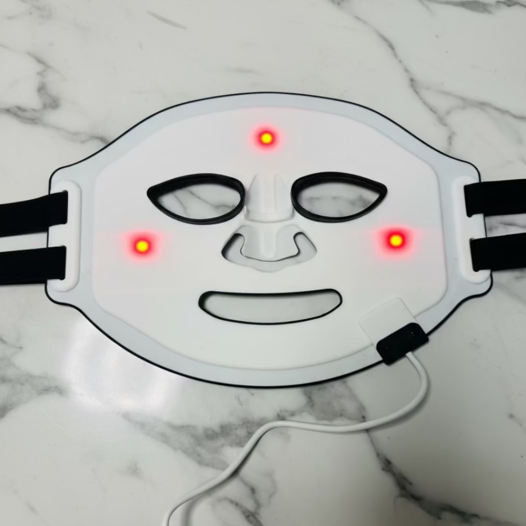 White LED face mask with red lights on a white background