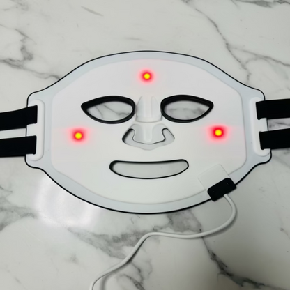 White LED face mask with red lights on a white background