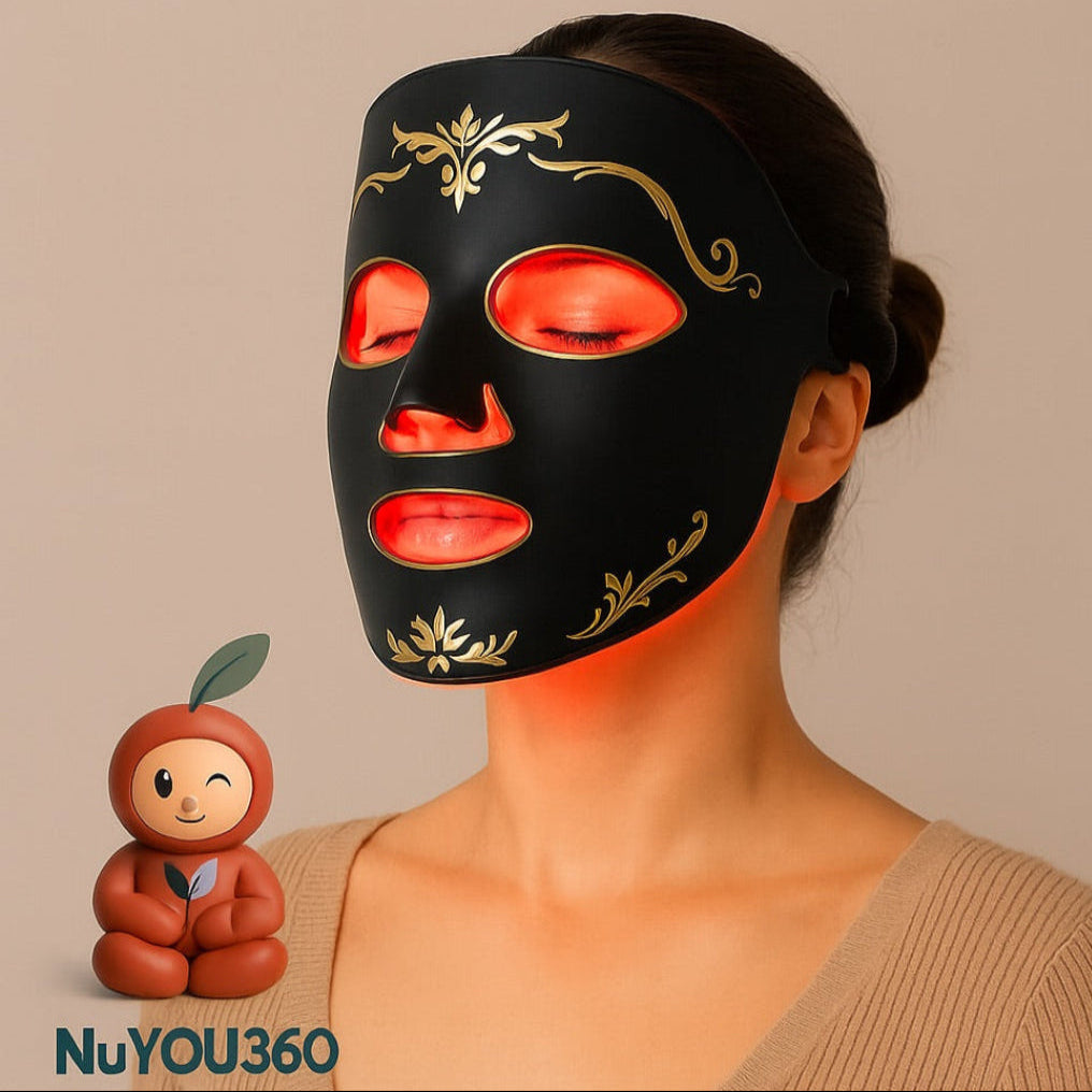 Woman wearing a black facial mask with decorative gold accents, holding a small figurine, on a beige background.