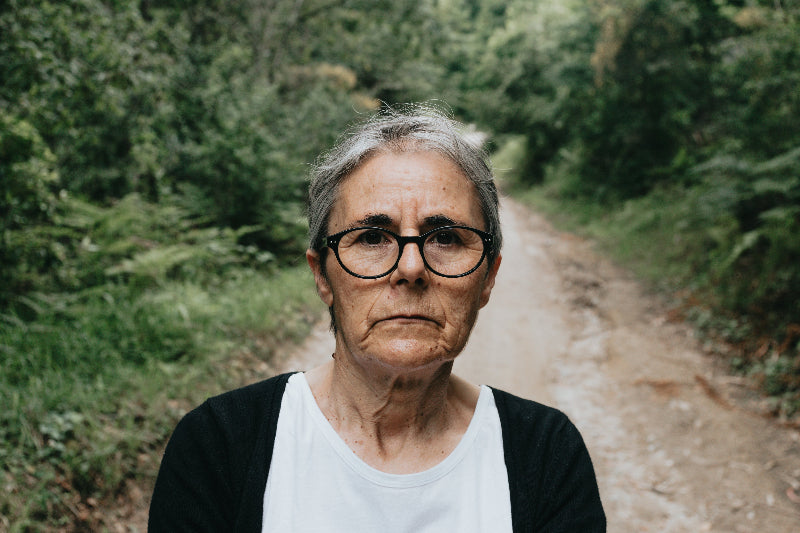 woman-in-glasses-looks-at-the-camera-with-a-trail-behind-her