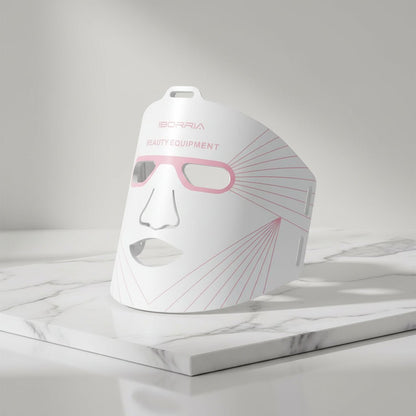 White beauty equipment mask with pink accents on a white background
