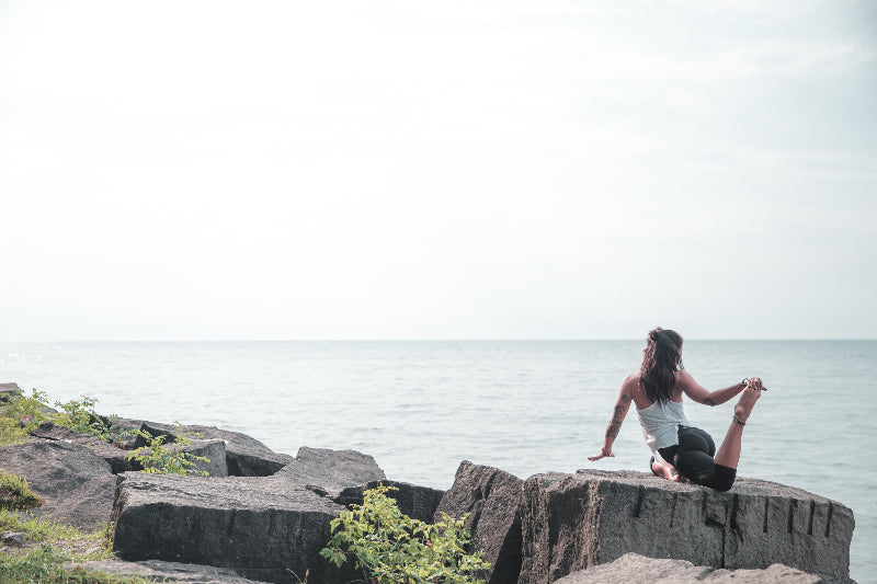 woman-does-yoga-by-the-water