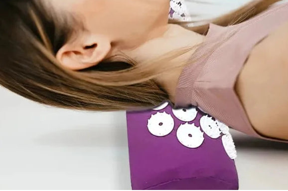 Person using an acupuncture massage pillow with text describing its benefits.
