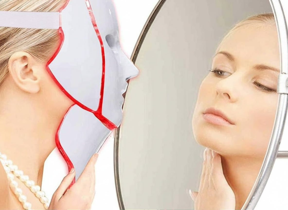 Woman using a LED face mask with a mirror reflection.